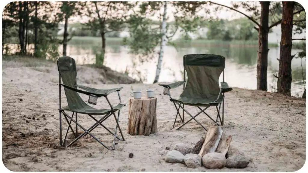 two camping chairs sit next to a campfire on the beach