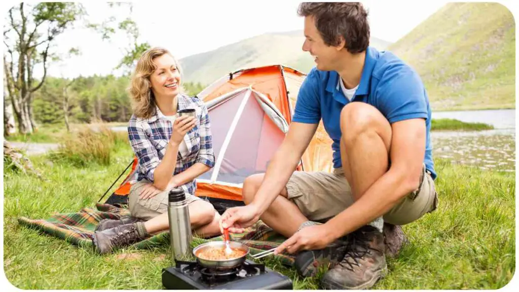 a person and another person are cooking food in front of a tent
